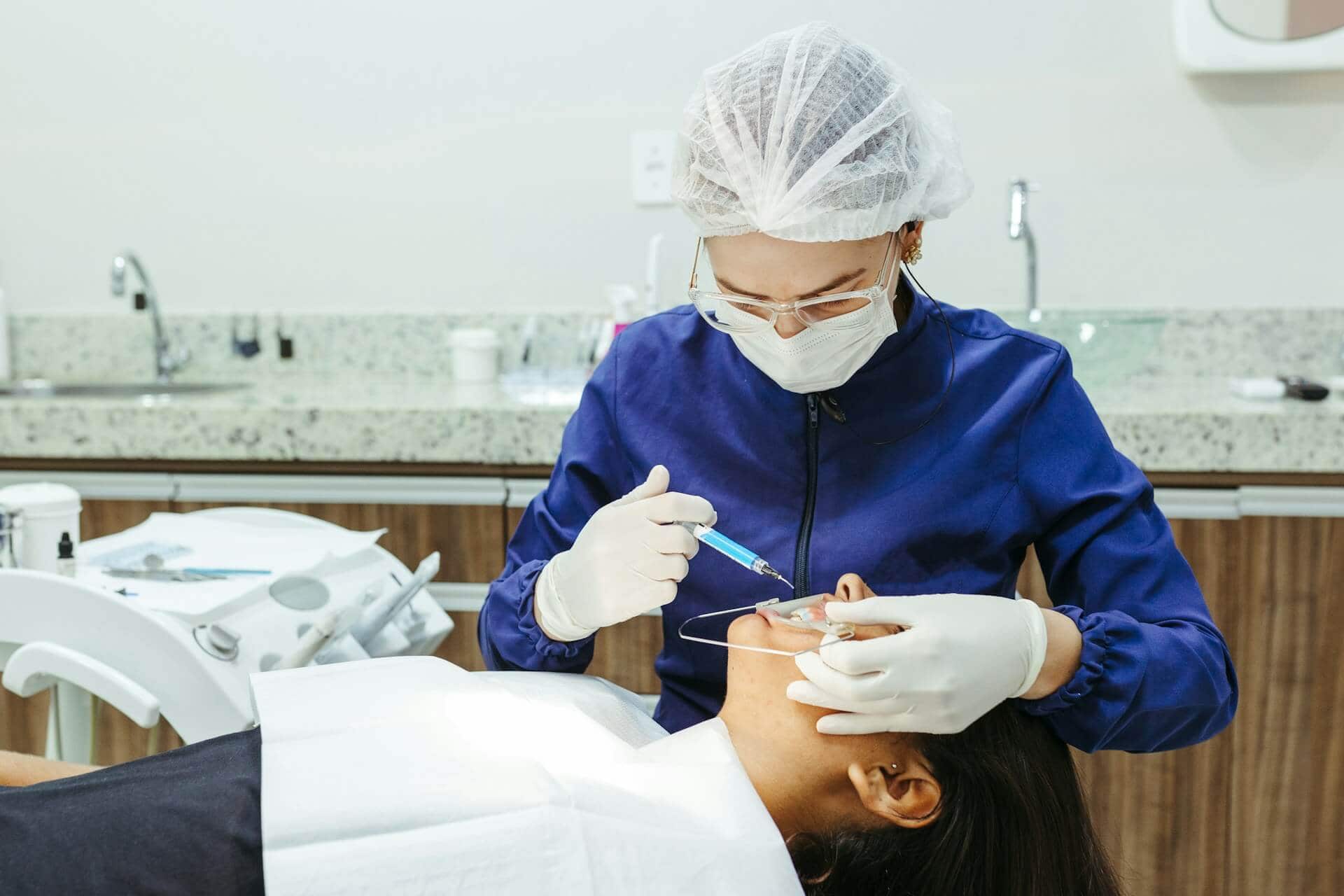 A woman working on a patient
