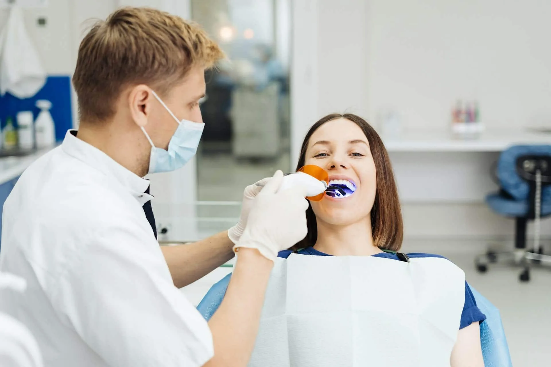 A person working on a patient's teeth