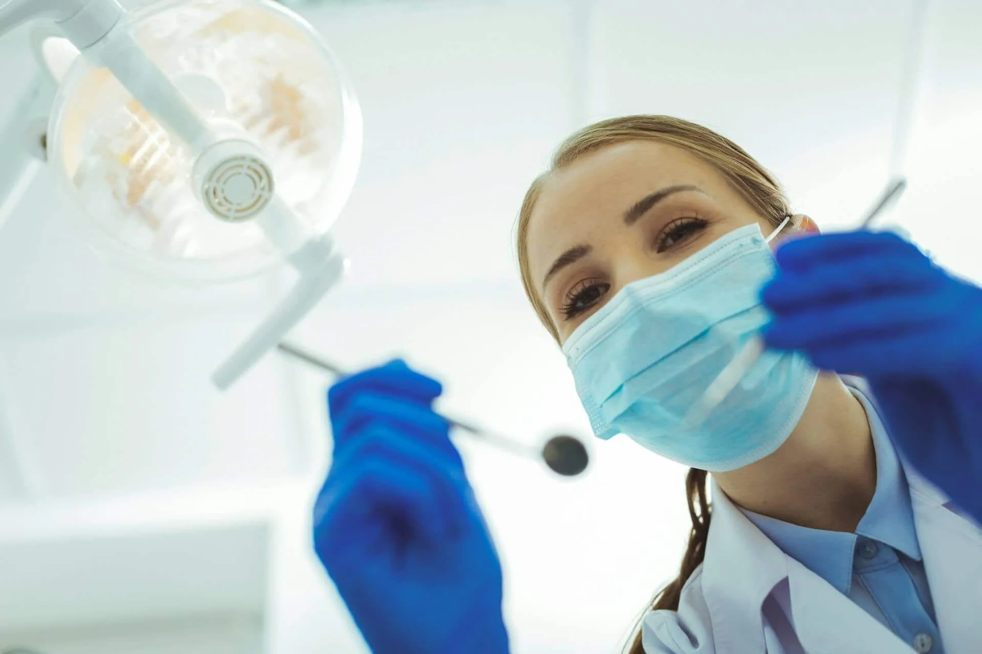 A person wearing a face mask and a glove